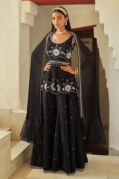 Black peplum kurta with embroidered floral motifs, pearl work and cutwork hem. Paired with embroidered sharara. Comes with frill hem dupatta.
Components:3
Pattern:Embroidered
Type of Work:Pearls, Floral motifs
Neckline:Scoop neck
Sleeve Length:Sleeveless
Fabric:Georgette
Color:Black
Other Details:
Embroidered motifs
Note: The hairband worn by the model is not for sale.
Occasion:Reception - Aza Fashions Black Chikankari Embroidery Sets For Reception, Sleeveless Embroidered Sharara For Eid, Embroidered Sleeveless Sharara For Eid, Embroidered Anarkali Sleeveless Sharara, Traditional Sleeveless Embellished Anarkali Set, Traditional Embellished Sleeveless Palazzo Set, Sleeveless Anarkali Sharara With Intricate Embroidery, Traditional Embellished Sleeveless Sharara, Elegant Sleeveless Embellished Anarkali Set