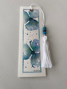 a bookmark with watercolor flowers and a tassel