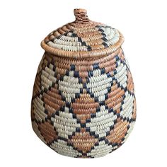 a large woven basket with a lid on the top and bottom, in multicolored patterns