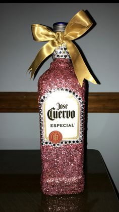 a bottle with a bow on it sitting on a table