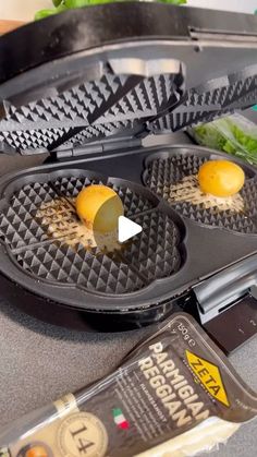 an open waffle iron with two lemons on it