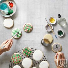 someone decorating decorated cookies on a table