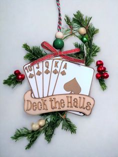 an ornament that says deck the haus hanging from a christmas tree with ornaments around it