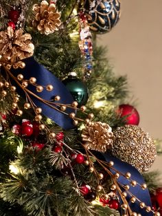 a christmas tree with blue ribbon and ornaments