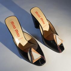 These stunning vintage Miu Miu leather sandals are absolute show-stoppers and are in perfect vintage condition (original box included). The bottoms have been re-soled with rubber soles for real-life use. The folded leather flower detail has a gorgeous combination of tan, cream, and burgundy that contrasts elegantly against the black leather; note how the stem of the flower wraps around the side of the peep-toe. These are early 2000s Miu Miu brilliance meets 1940s glamour. The Heel is 4 inches tall and they are sized EU 38 / US 7. 1940s Glamour, Vintage Leather Sandals, Mules Sandals, Leather Flower, Womens Mules, Leather Flowers, Mule Sandals, Flower Detail, Early 2000s