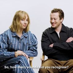 a man and woman sitting next to each other with their arms crossed in front of them