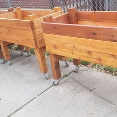 two wooden planters sitting on top of each other