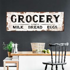 a wooden sign that says grocery milk bread eggs on the wall next to a chair