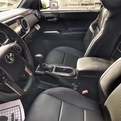 the interior of a car with black leather seats