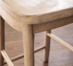 a wooden chair sitting on top of a hard wood floor