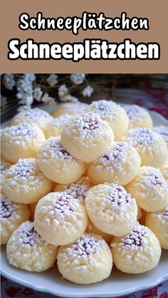 a white plate topped with cookies covered in powdered sugar on top of a table