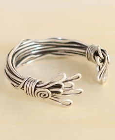 This bracelet’s pewter wires are bundled together and accented with spiral and loop motifs that resemble wild flames! Bracelet is handmade in Turkey and measures about 8 inches around. The bracelet’s open design can be adjusted to fit most wrist sizes. Band width is about 0.375 inches all around and 1 inch on either end. Fire and flame bundle bracelet Made of pewter Bracelet is 8 inches around Band is 0.375 to 1 inches wide Open design with adjustable fit Made in Turkey Beauty isn't perfect, it's authentic. This piece is artistically created by hand where beauty and imperfections go together wonderfully. Please accept and appreciate minor imperfections and variations which are true characteristic of this craft. Tassels Decor, Stamp Blocks, Tin Gifts, Open Design, Gemstone Bracelets, Gemstone Necklace, Gemstone Pendant, Gemstone Earrings, Sales Gifts