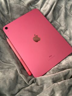 an apple ipad is sitting on a bed