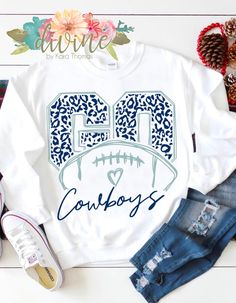 a white shirt with the word cowboys on it and an image of a football helmet