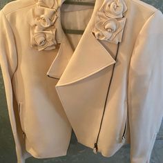 Excellent Condition-No Exterior Marks, Never Worn. Cream Fabric With Rosette Design On Collar, Silver Hardware. Size 6, Medium. 2 Side Zipper Pockets Chic Long Sleeve Biker Jacket For Formal Occasions, Chic Formal Biker Jacket For Spring, Chic Fitted Biker Jacket For Office, Chic Winter Biker Jacket For Formal Occasions, Designer Biker Jacket With Zipper For Spring, Designer Biker Jacket With Zipper Closure For Spring, Luxury Biker Jacket For Spring Workwear, Elegant Biker Jacket For Work, Chic Formal Blazer With Zipper Closure