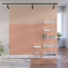 a living room with an orange and pink color scheme on the wall next to a white chair