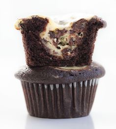 a chocolate cupcake with white frosting on top