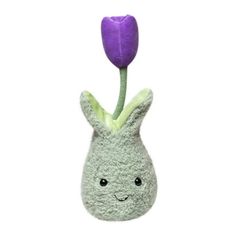 a stuffed animal with a purple flower sticking out of it's back end, on a white background