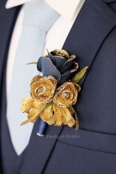 a man wearing a blue suit with gold flowers on it's lapel pin