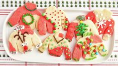 christmas cookies are on a plate with candy