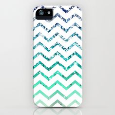 an iphone case with green and white chevrons on the front, sitting against a white background