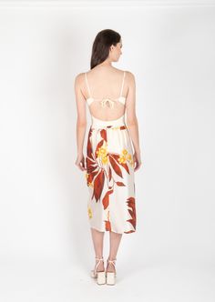 Product Description: Cut from a luxurious silk fabric, the Erin skirt is defined by its side ruching and flattering shape. A handkerchief hem with slit opening emphasizes the piece's airy feel and gives its beautiful movement. Rendered in resort brown tropical print. Pair effortlessly with our solid Tina silk blouse or simple white shirt. Fabric: 100% Silk Color: Brown Tropical Size and Fit: Our model is 5'11" and is wearing a size S. Care Instructions: Cold Hand Wash or Dry Clean White Shirt Fabric, Cold Hands, Midi Length Skirts, Handkerchief Hem, Simple White, Shirt Fabric, Drop Waist, Tropical Print, Silk Blouse