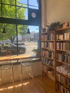 a table and chairs in front of a window with a view of the street outside