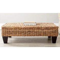 a wicker coffee table sitting on top of a hard wood floor