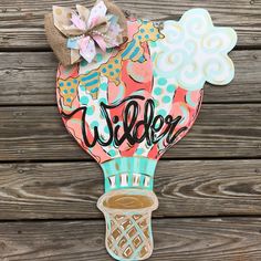 a paper hot air balloon with the word wilder on it and a cup of coffee