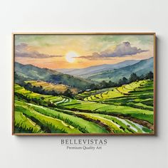 a painting hanging on the wall in front of a white wall with a green field and mountains