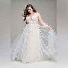 a woman in a white wedding dress is posing for the camera with her hands on her hips