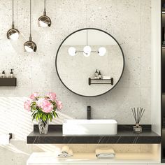 a bathroom sink sitting under a mirror next to a vase with flowers on top of it