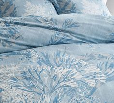 a bed with blue and white floral designs on it