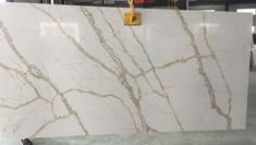 white marble with gold veining on the top and bottom, as well as an orange handle