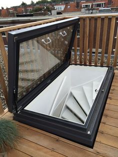 an open window on top of a wooden deck