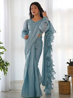 This exquisite saree is made from high-quality organza material in a beautiful blue color, featuring ruffle details and fancy lace border work that adds a touch of sophistication to your outfit. The saree comes in a 5.50 meters length, ready-to-wear, and includes a fully stitched blouse material, available in sizes XS to XXL for your convenience.
This saree include its trendy lace work that creates a fashion statement, making it perfect for parties, receptions, or any special occasion where you Saree Ruffle, Ruffled Saree, Ruffle Sarees, Sari Design, Party Wear Lehenga Choli, Jacquard Blouse, Ruffle Saree, Readymade Saree, Ready To Wear Saree