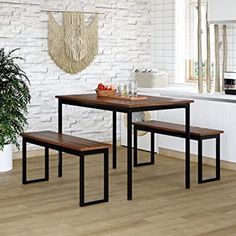 a kitchen table with two benches and a potted plant