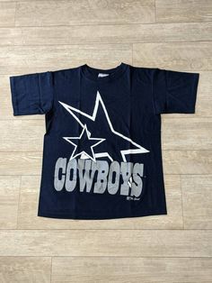 "Vintage 90s Dallas Cowboys Blue Single Stitch T-shirt. Has light wear. NO holes or major stains. In good vintage condition... Ready To Wear!! Size Med. Measurements: Pit to Pit: 20 3/4\" Collar to Bottom: 25 1/4\" Pit to End of Sleeve: 6 1/4\"" Blue Cotton Throwback T-shirt, 90s Blue Short Sleeve T-shirt, 90s Style Blue Short Sleeve T-shirt, Vintage Dallas Cowboys, Shirts Vintage, Mens Graphic Tee, Dallas Cowboys, Fancy Dresses, Vintage 90s