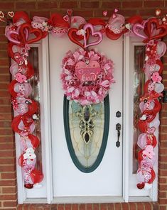 valentine's day decorations on the front door of a house with hearts and flowers