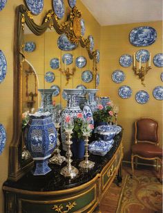 blue and white vases are sitting on a dresser