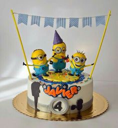 a birthday cake with three minion characters on it