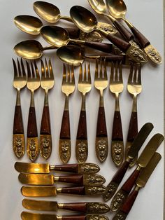 an assortment of antique spoons and forks