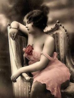 an old fashion photo of a woman sitting in a chair with her arm on the back of a chair