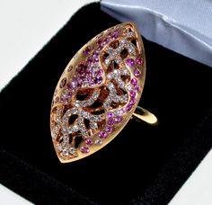 Breath taking 18K rose gold diamonds and pink sapphire cocktail ring by Swiss designer Bucherer new with tag. The ring retail price is $7530. The house of Bucherer has been known since 1888. The ring designed and completed with highest craftsmanship throughout, front, back, and the band. The domed football shape top decorated with sophisticated openwork pattern covered with sparkling diamonds and pink sapphires. There are approx. 0.85 CTW of diamonds, 1.10 CTW sapphires. The top is 36 mm long, 2 Luxury Marquise Ruby Ring, Luxury Pink Sapphire Ring For Formal Occasions, Luxury Pink Gold Ruby Ring, Luxury Pink Ruby Ring For Formal Occasions, Luxury Pink Gold Ring With Pink Sapphire, Luxury Pink Sapphire Ring With Pave Setting, Formal Pink Sapphire Ring With Pave Setting, Formal Pink Gold Diamond Ring With Accents, Luxury Pink Diamond Ring With Single Cut Diamonds