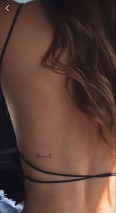 the back of a woman's neck with writing on it