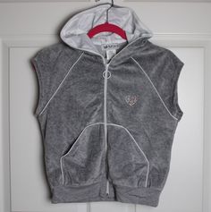 Description: new with tags vintage 90s/00s/y2k-era Self Esteem grey velour tracksuit sleeveless hoodie (ONLY--NO pants), multicolor rhinestone heart on front, white trim, satin-lined hood, split kangaroo pocket front, size large juniors. *Please note that clothing from this era is priced higher than original MSRP due to demand. Details/Measurements fabric: 80% cotton/20% polyester underarm to underarm - 20" length in back, neck to hem - 20" Customer satisfaction is my priority, so please read be Oversized Y2k Hooded Top, Y2k Streetwear Hoodie With Drawstring Hood, 90s Cotton Hooded Top, 90s Cotton Hoodie With Drawstring Hood, Y2k Velour Tracksuit, Velour Tracksuit, Y2k Era, Hoodie Vest, Sleeveless Hoodie