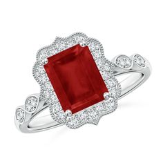 an engagement ring with a red stone surrounded by diamonds