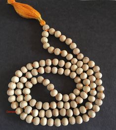 "Tulsi Mala necklace, 108 + 1 Premium beads in Hand Knotted Mala Tulsi beads are made from Tulsi (Holy Basil) plant wood, considered as most sacred in India. Tulsi plant is worshipped in India and the food offered to Indian Gods is incomplete without the offereing of Tulsi leaves along with it. Tulsi Mala provides protection to the wearer and is said to maintain Health, provide Peace of Mind and reduce Stress. They are used to worship Lord Krishna to honour him and to get his blessings. Since th White Spiritual Jewelry With Wooden Beads, Spiritual White Jewelry With Wooden Beads, Meditation Necklace With Round Wooden Beads, Meditation Necklaces With Round Wooden Beads, Wooden Beads Necklace For Meditation, Wooden Bead Necklaces For Meditation, Spiritual Mala With Round Wooden Beads, Spiritual Mala With Polished Beads, Spiritual Mala With 8mm Beads