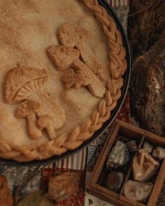 a pie sitting on top of a table covered in cookies