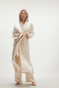 Drape yourself in opulence with the Brigitte Silk Robe. The ultimate luxury for chilly mornings or after a hot shower. 100% Silk Charmeuse Open-front robe with tie-waist Patch pockets Contrast piping 52" length (size small) Dry Clean Only All sale items are FINAL SALE. Luxury Long Sleeve Robe For Spring, Luxury Long Sleeve Spring Robe, Elegant Cream Silk Robe, Elegant Silk Robe With Tie Waist, Elegant Beige Long Sleeve Robe, Elegant Long Sleeve Beige Robe, Formal Luxury Silk Robe, Chic Long Robe For Daywear, Elegant Shawl Collar Loungewear Robe